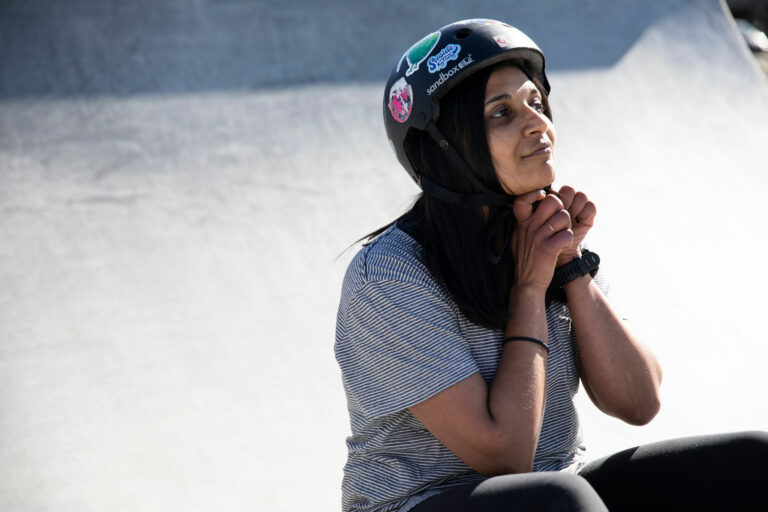 roller skater putting on helmet